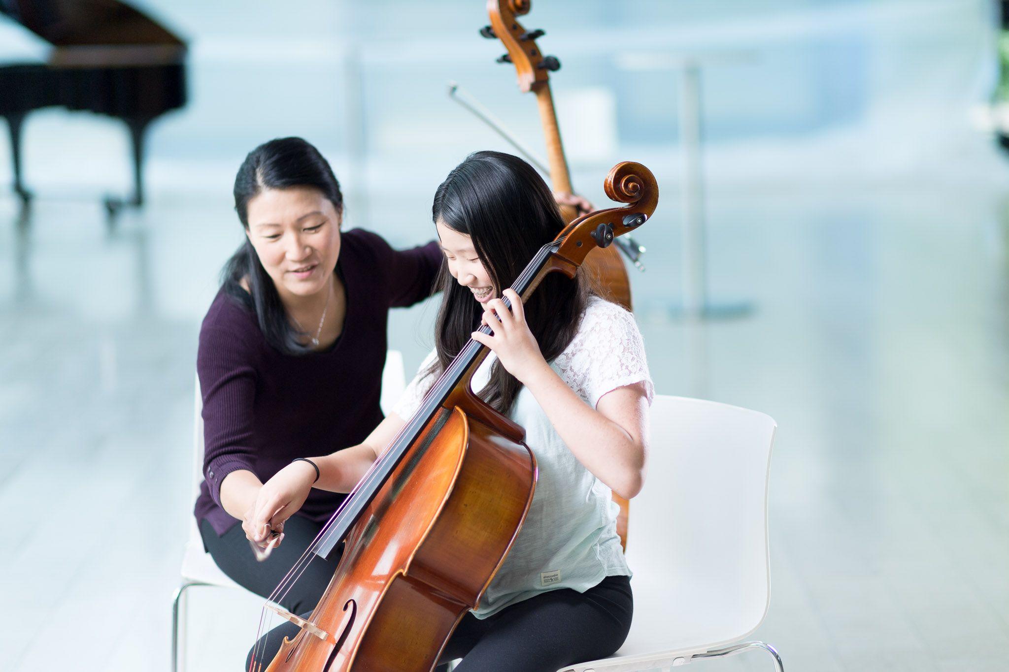 Student and teacher playing cello
