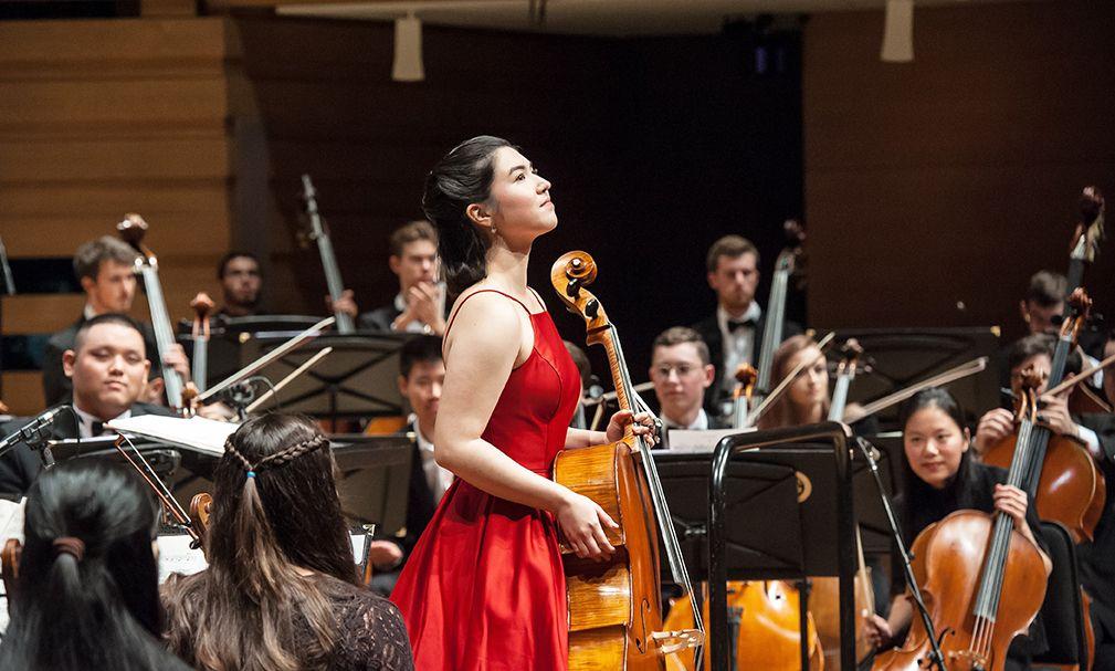 Teacher and student holding violin