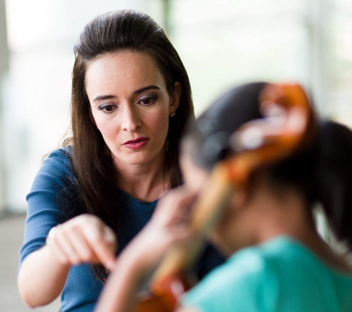 Teacher shows how play viola