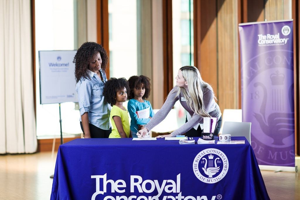 The Royal Conservatory staff talking to woman and kids