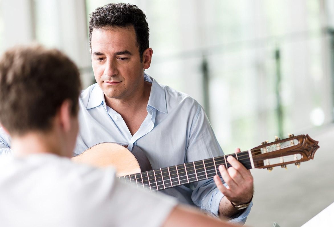 guitar teacher teaching student
