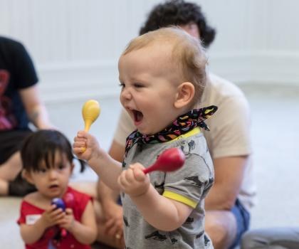 toddler holding maracas
