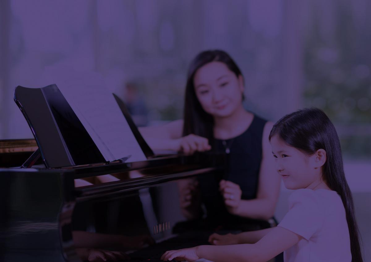 Teacher and student at piano