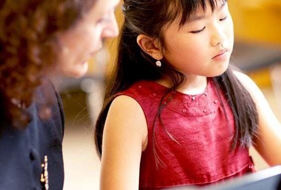 small girl listened to her teacher