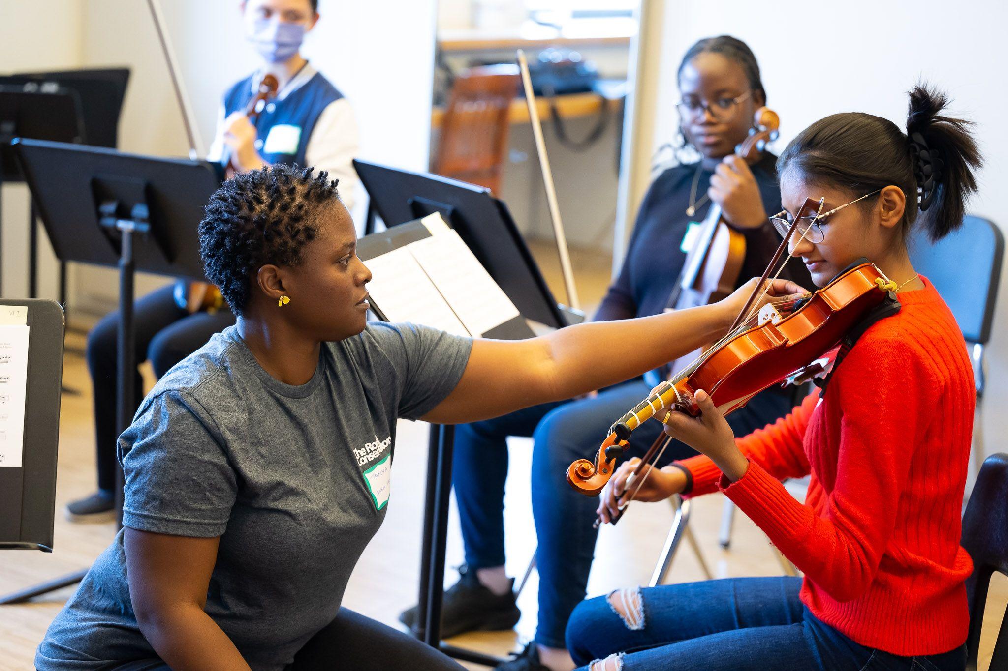 Mentor helping violin student