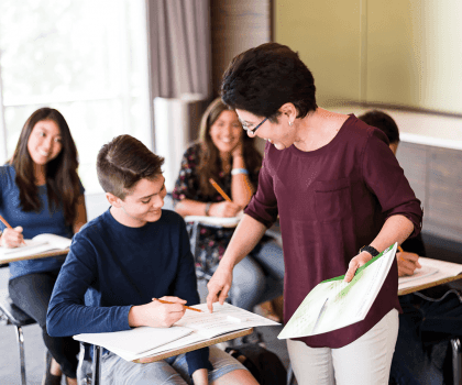 teacher pointing at student's paper