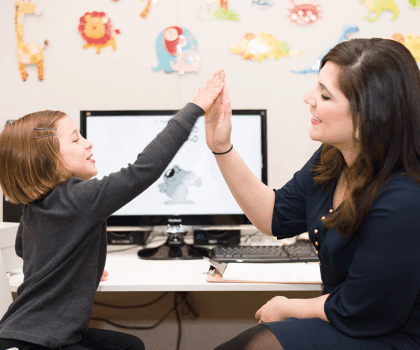 woman high-fiving child